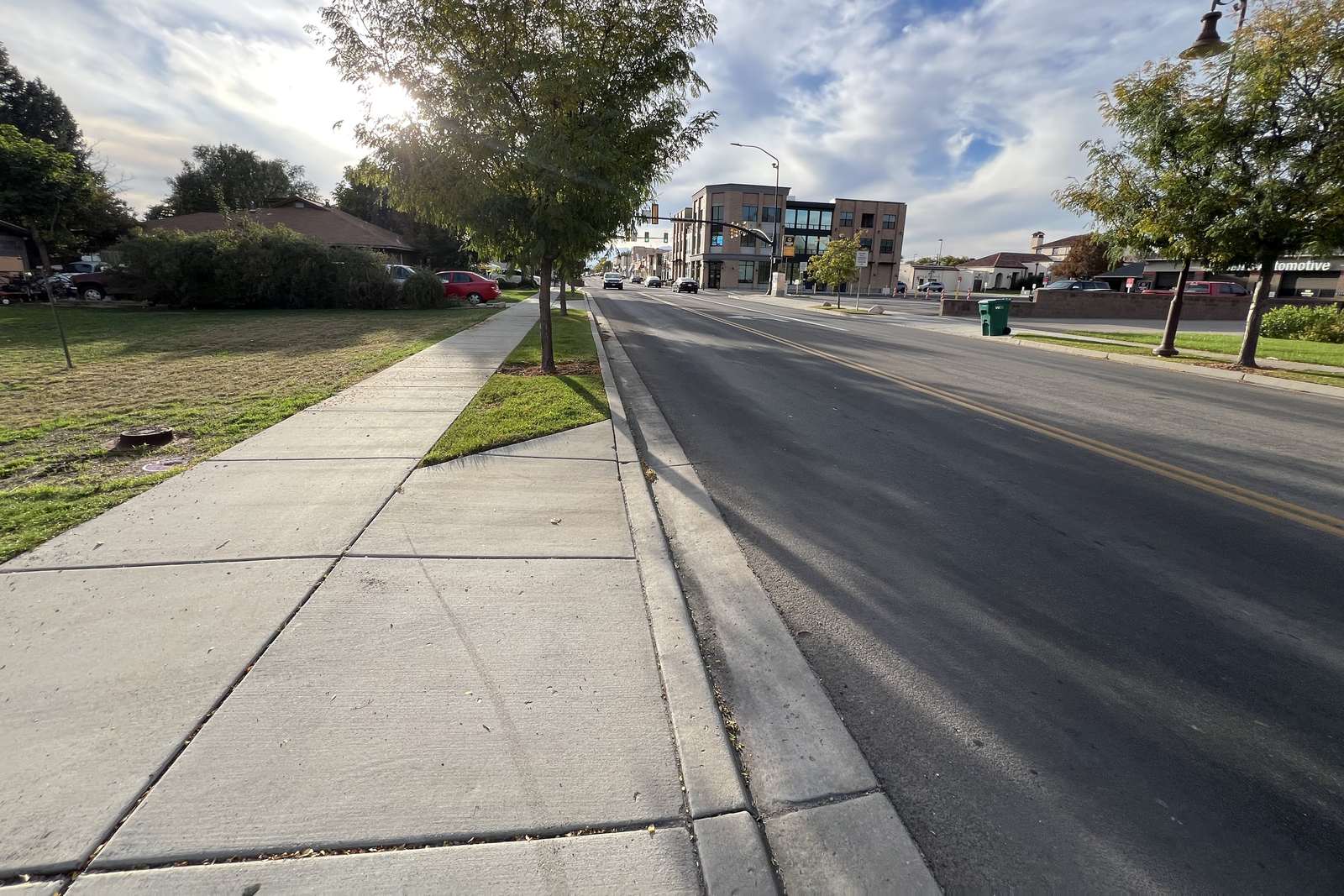 Main Street in Lehi looking toward downtown, with the lot on the left and street trees along the sidewalk.